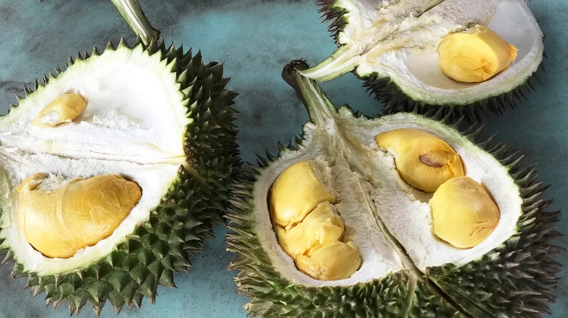 durian fruits cut open to reveal pulp